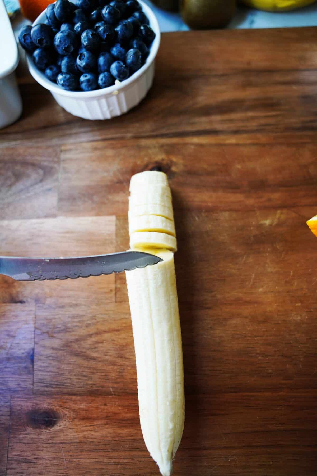 slicing banana on cutting board