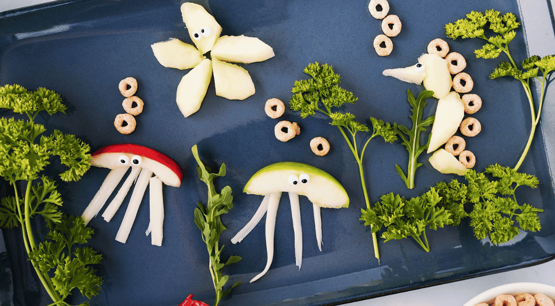 Under the Sea creatures made from apples on blue plate
