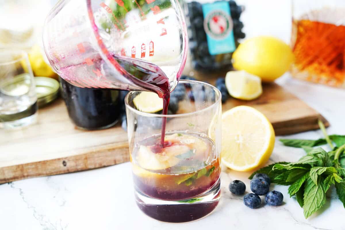 Blueberry simple syrup mixed with bourbon, and tonic water.