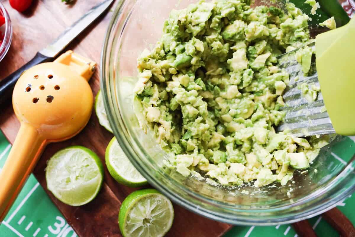 Mashing Avocado in glass bowl