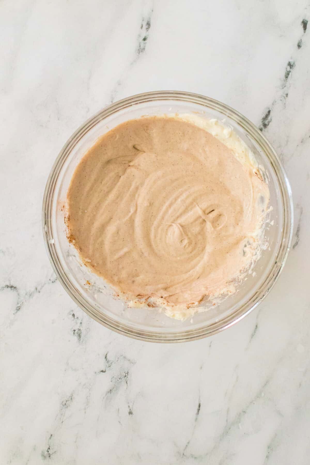 cheesecake filling in glass bowl creamed together