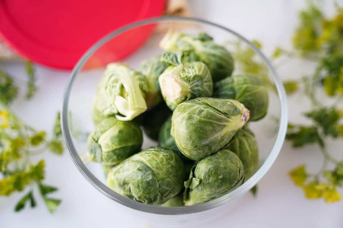 Whole Brussels sprouts in glass container
