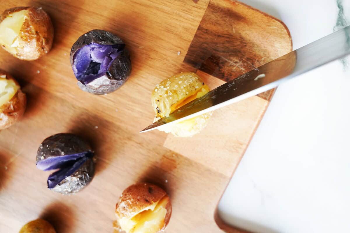 Cut a slit in the tops of the potatoes.