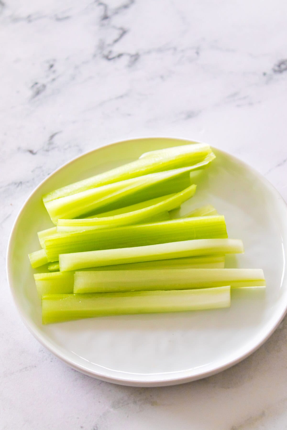 celery sticks on white plate