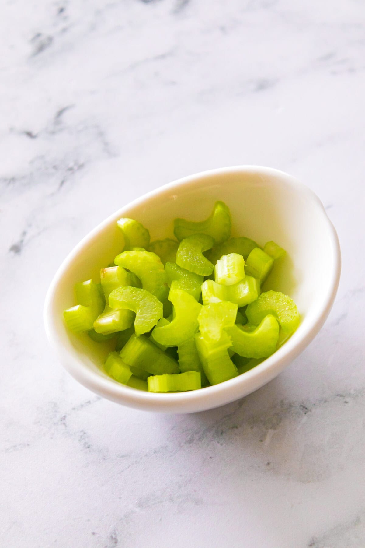 celery cut into c's in white bowl