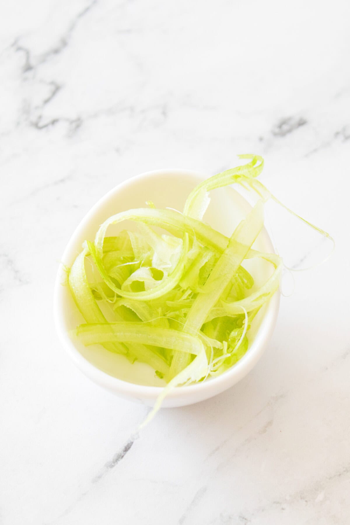 shaved celery in white bowl