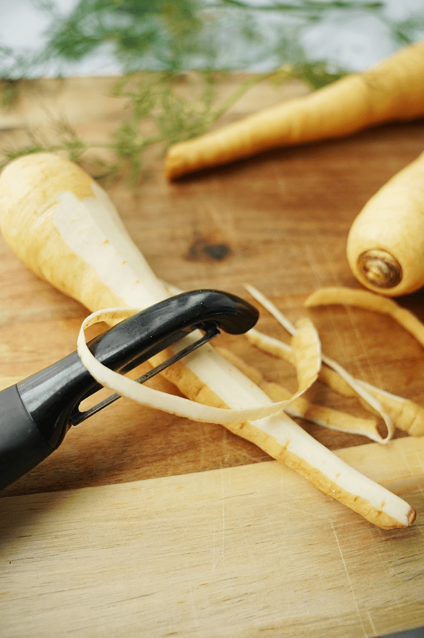 Peeling a parsnip with a vegetable peeler