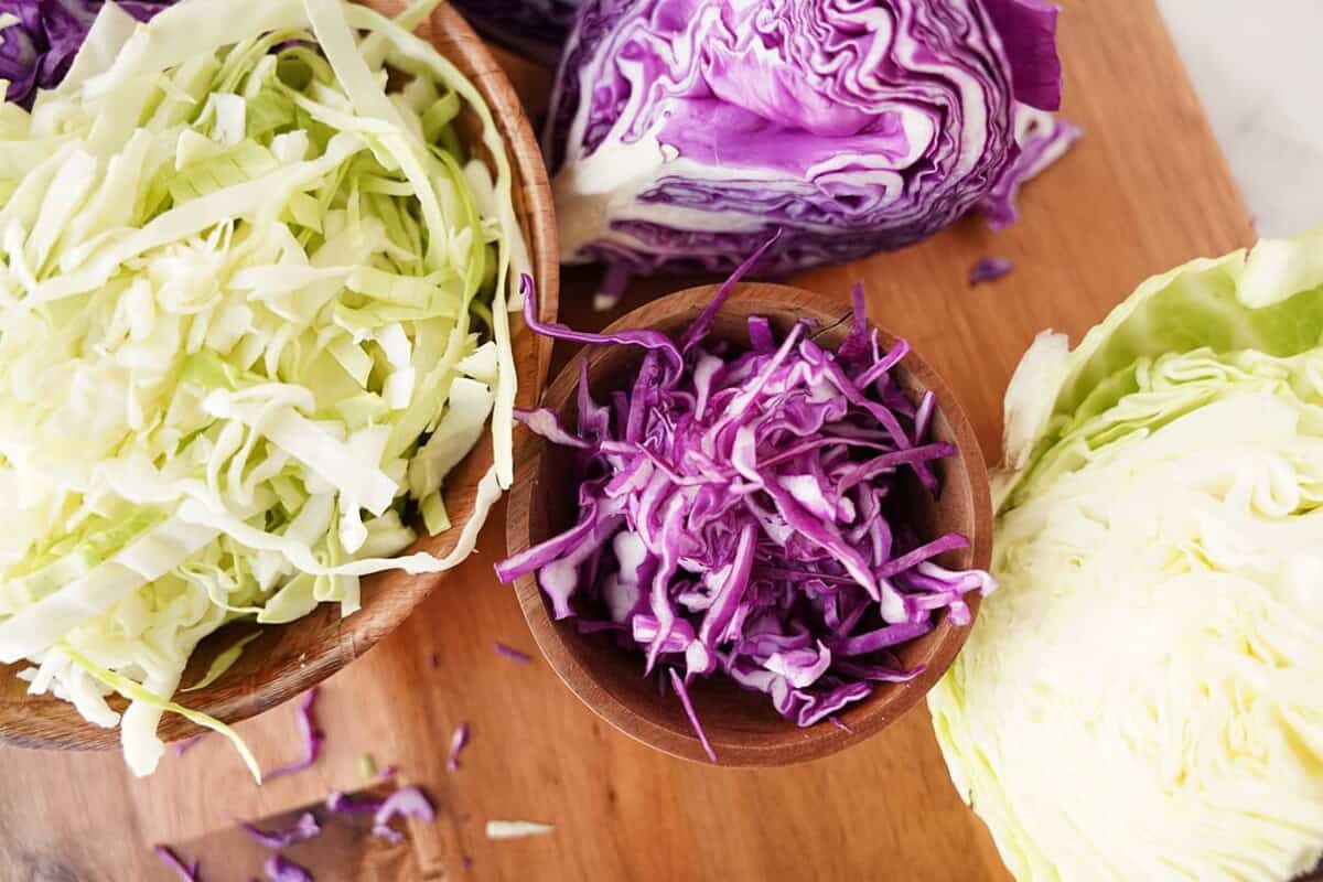 overhead view of shredded cabbage in bowls