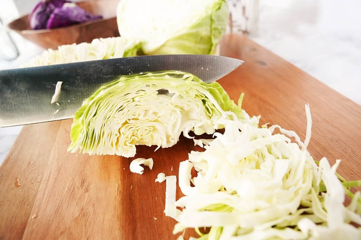 Shredding cabbage on cutting board