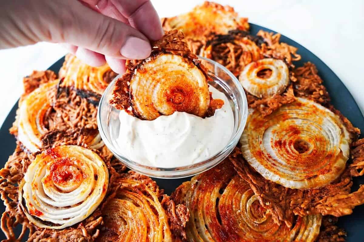 Crispy Onion Chips on a plate with Chip in Dip