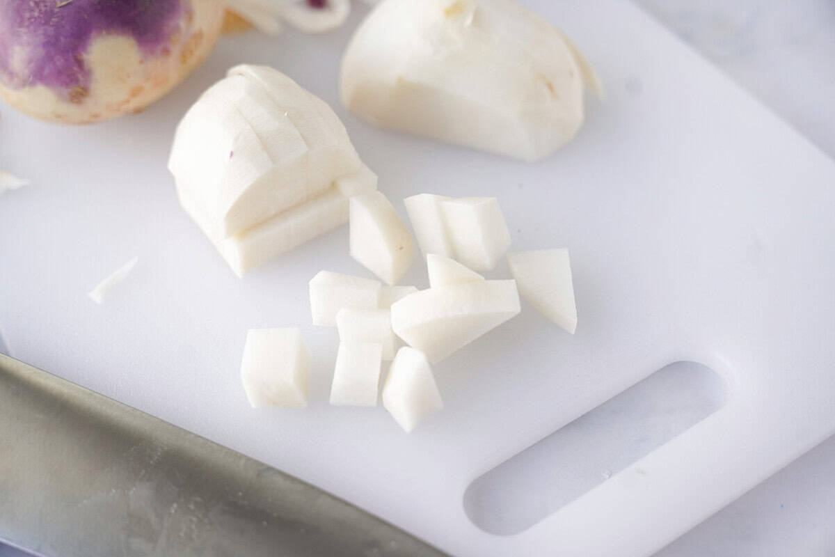 cubed turnips on white cutting board