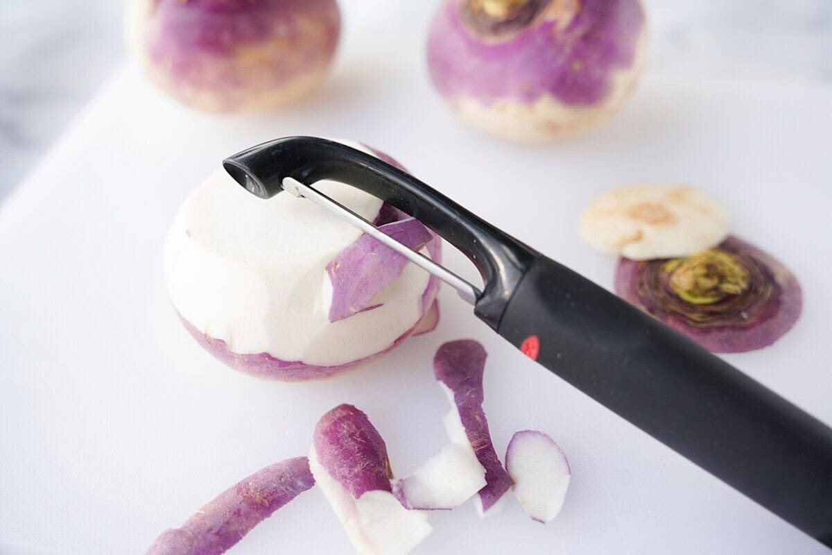 Peeling turnip skin with vegetable peeler