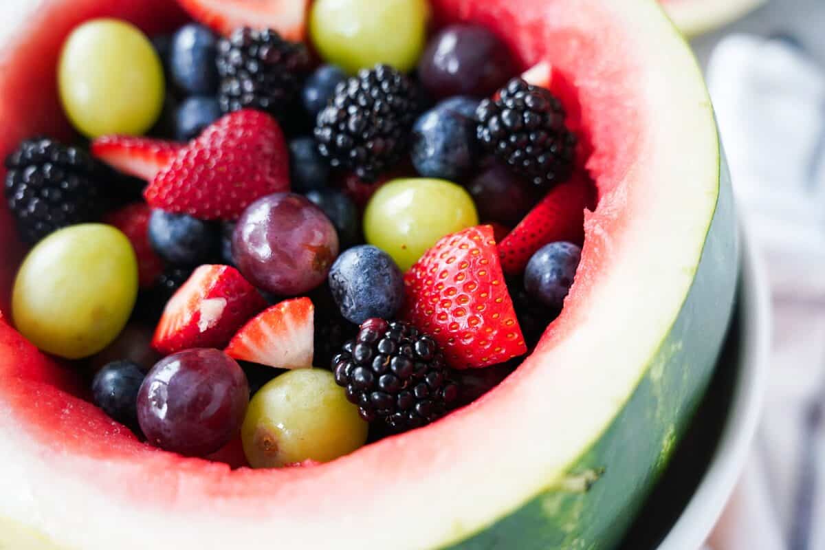 watermelon packed with fresh fruit: grapes, strawberries, blackberries, blueberries
