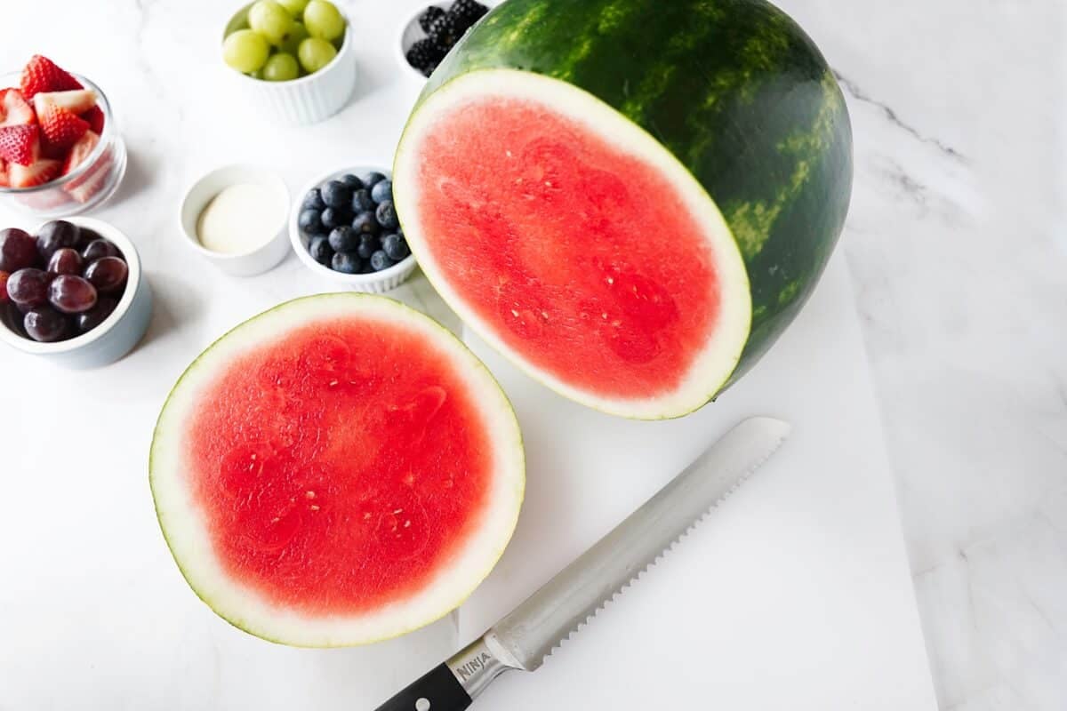 slice of watermelon with end cut off on cutting board