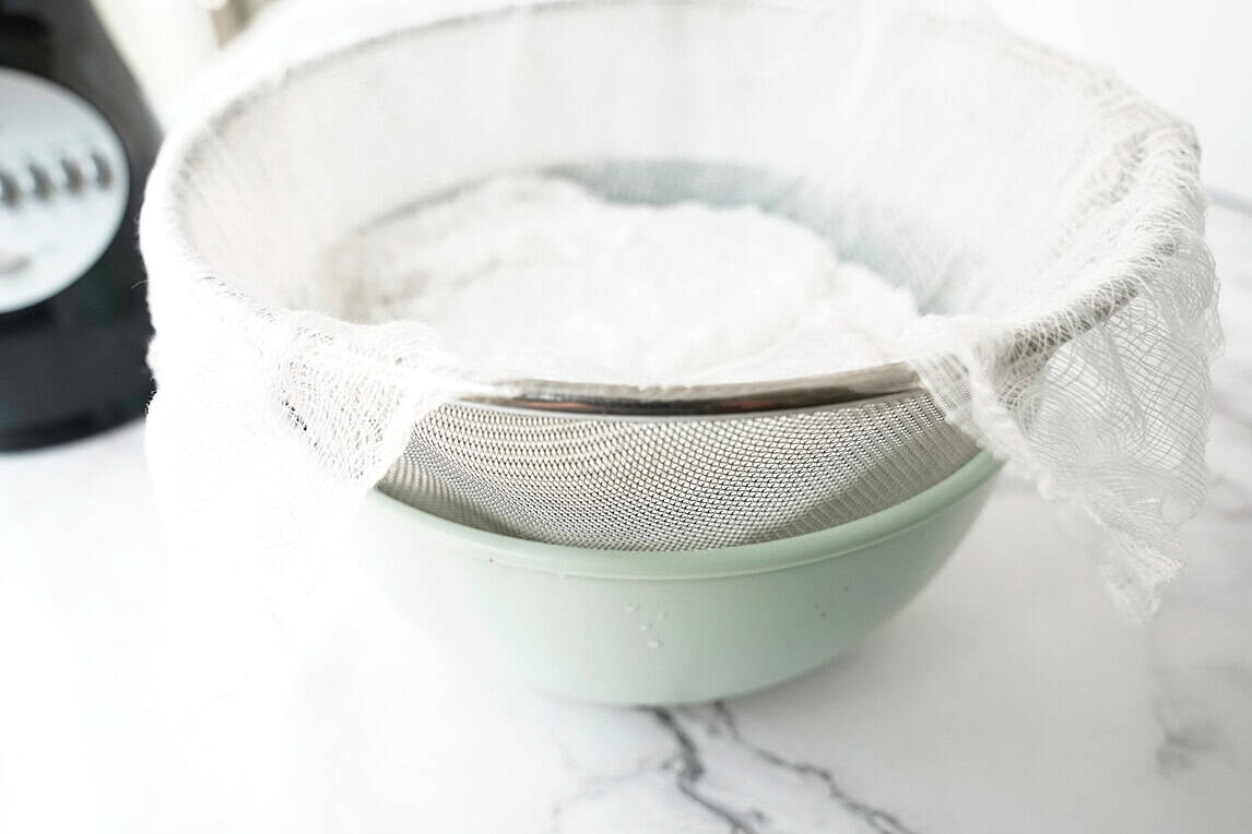 side view of shredded coconut in sieve