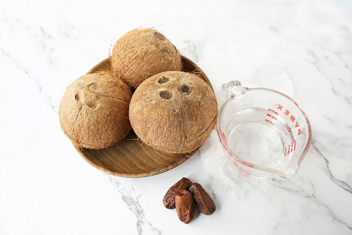 Ingredients to make homemade coconut milk: coconut, dates, water