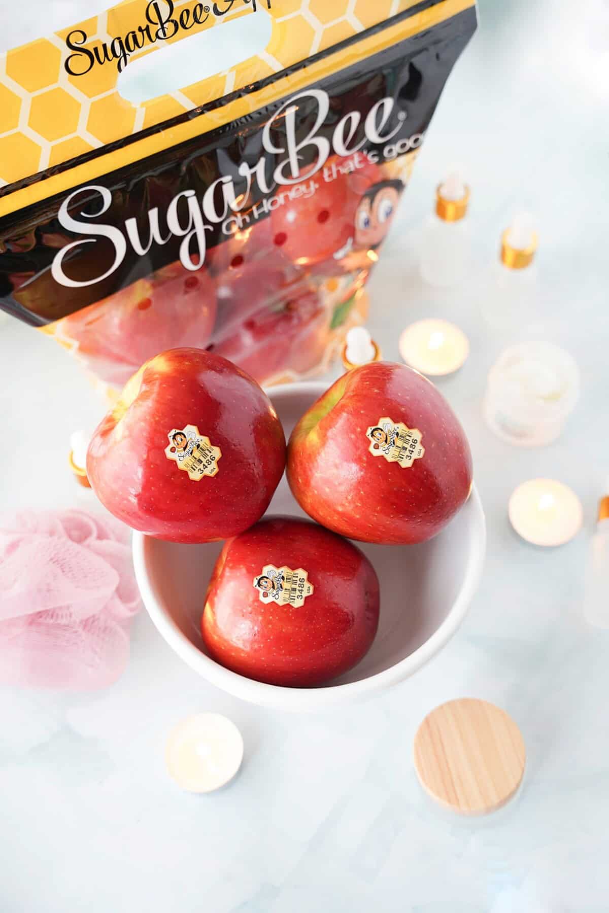 Vertical SugarBee apples in a bowl with bag behind