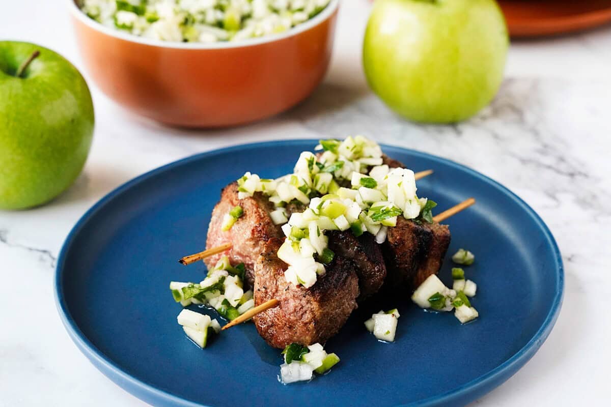 Serve apple chimichurri with grilled steak skewers.