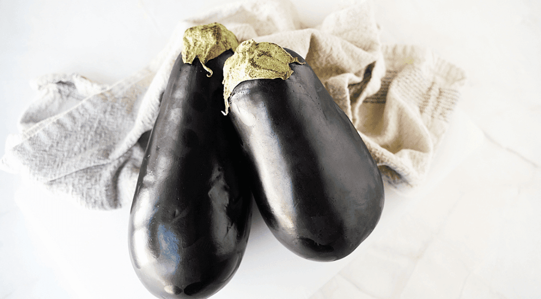 2 full eggplants on kitchen counter