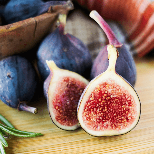 Up close look at a cut fig with whole figs in background