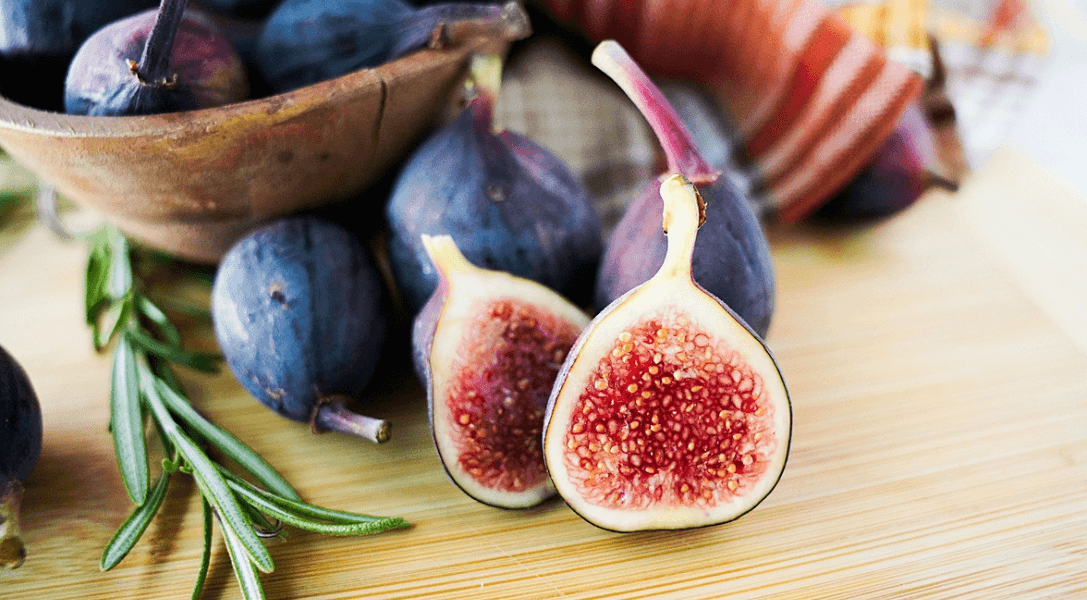 Up close look at a cut fig with whole figs in background