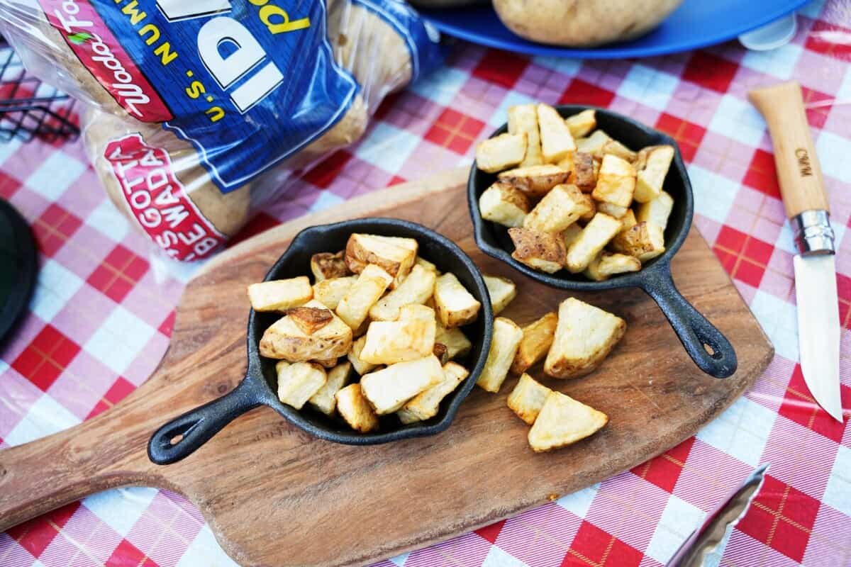 Roasted potatoes in mini cast iron skillets on cutting board