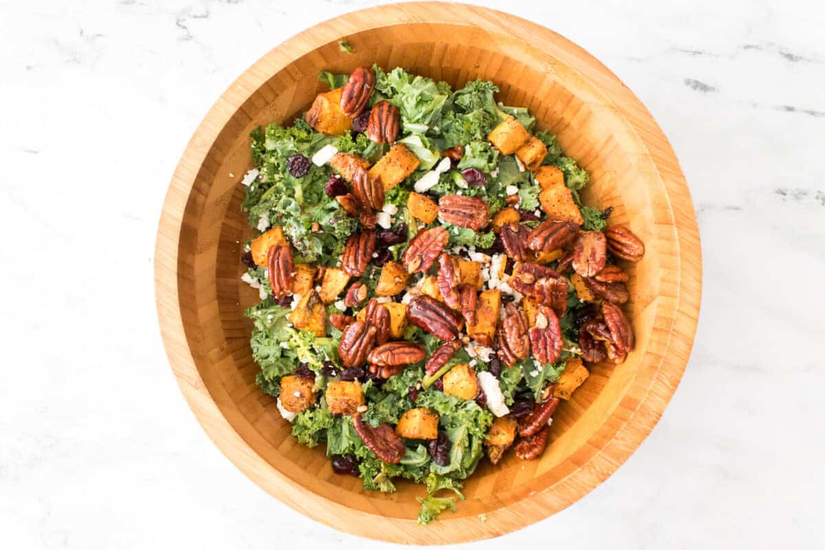 overhead shot of bamboo salad bowl with roasted sweet potato kale salad