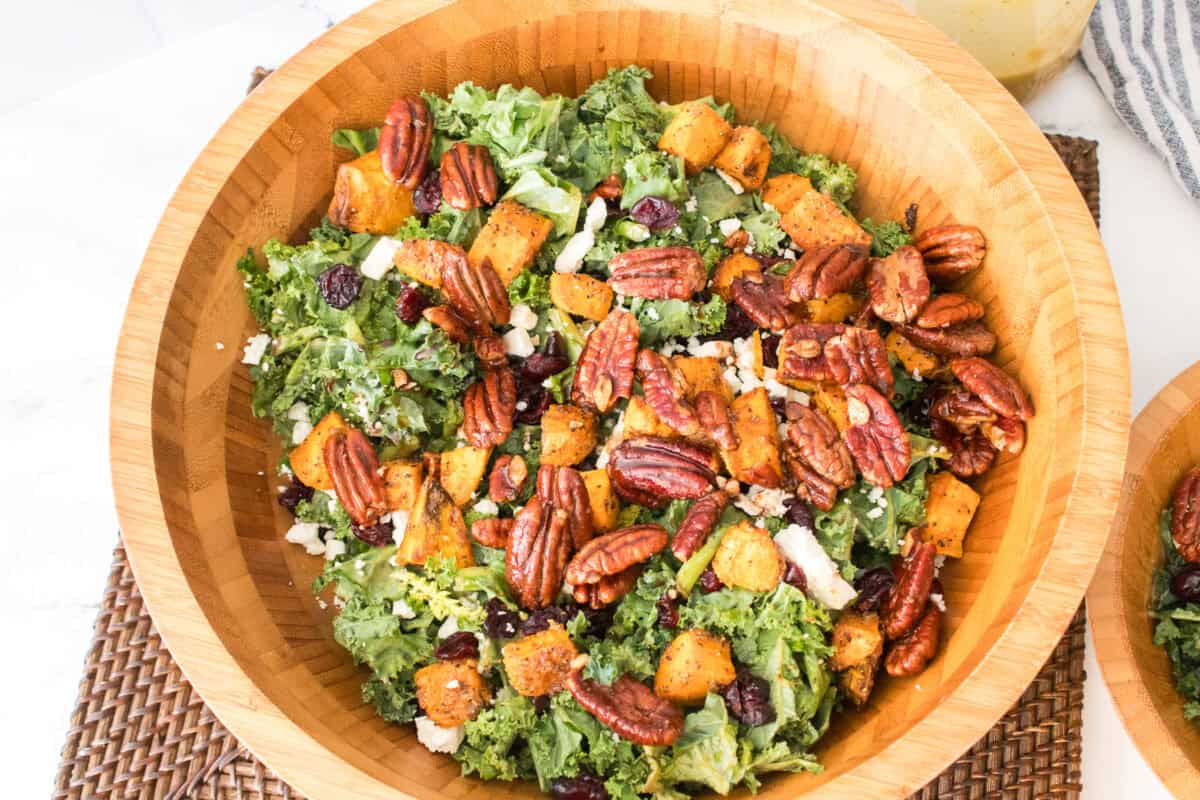 overhead shot of sweet potato salad with kale, feta cheese and candied pecans