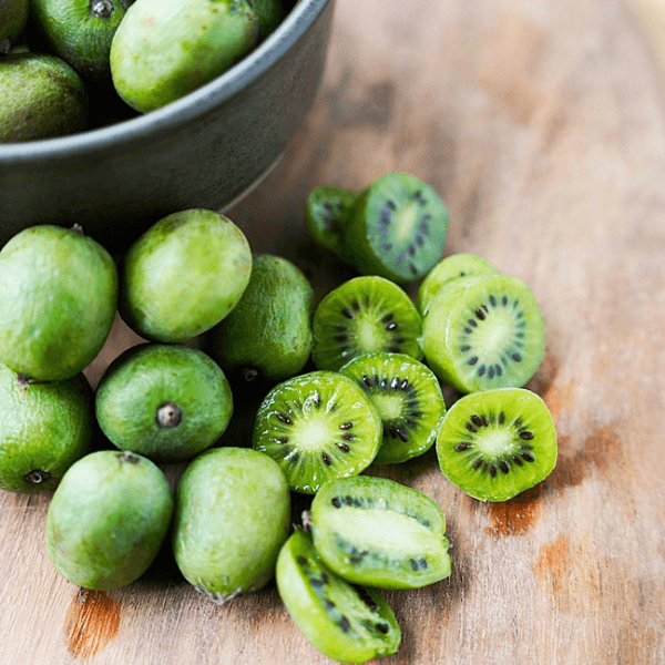 Kiwi Berries on cutting board - some whole and some cut in half
