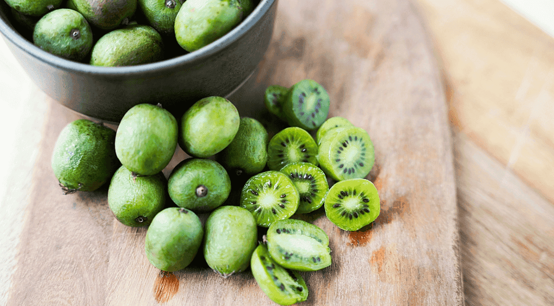 Kiwi Berries on cutting board - some whole and some cut in half