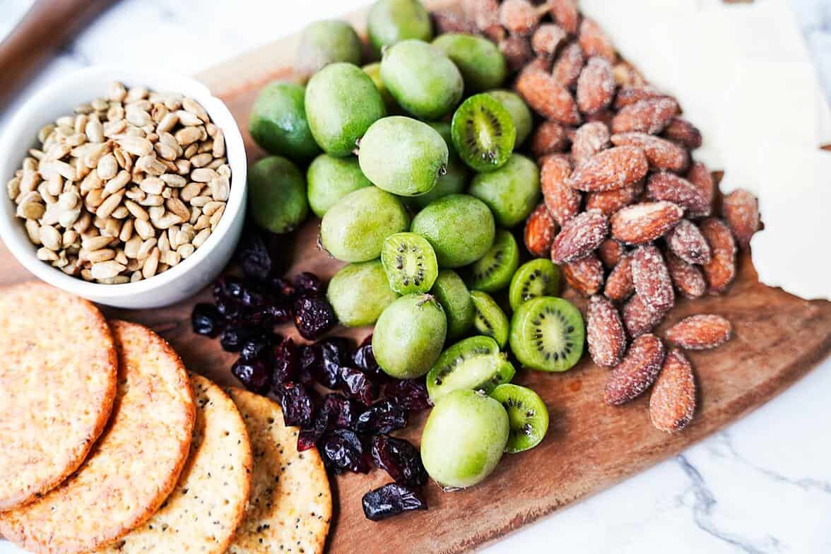 Kiwi berries placed in the center of a charcuterie board