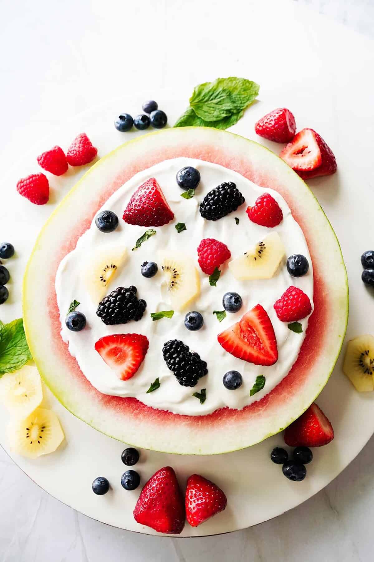 vertical image of watermelon pizza on board