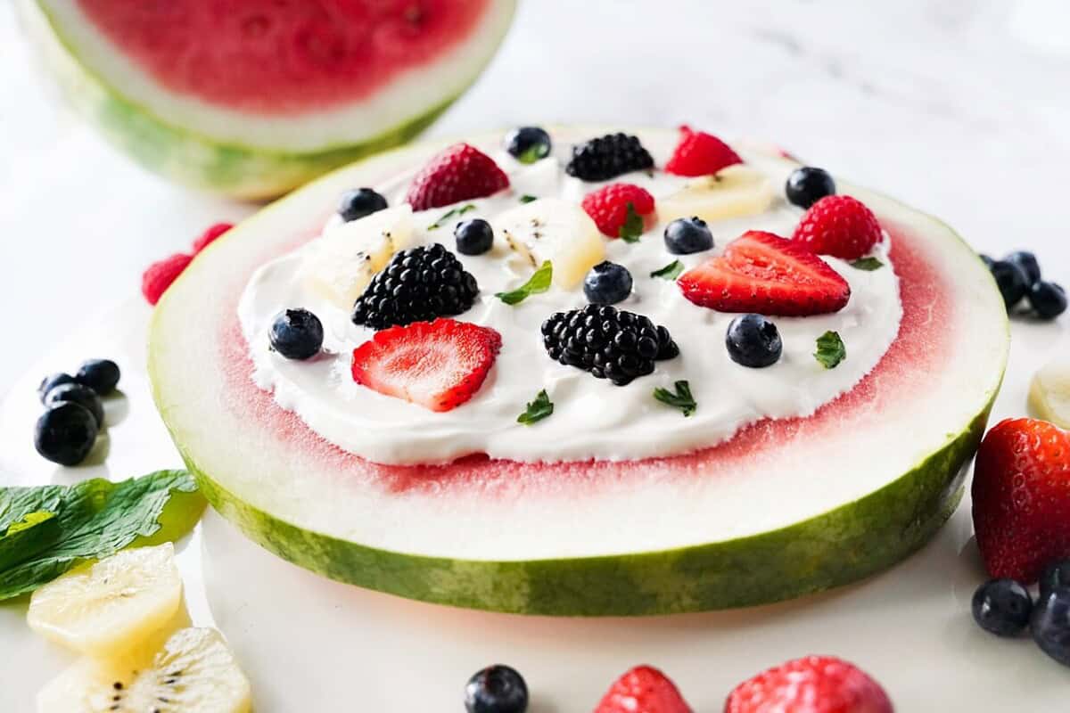 side view of watermelon pizza with berries