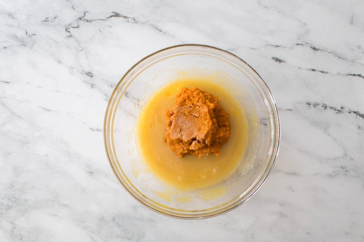 bowl mixture of oil sugar, eggs and pumpkin puree