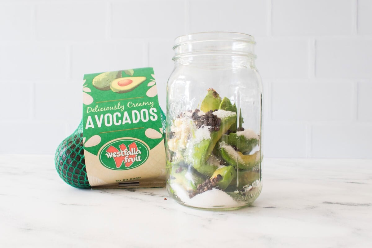 bag of westfalia fruit avocados with big mouth mason jar with avocados, peppercorns, red pepper flakes and sugar