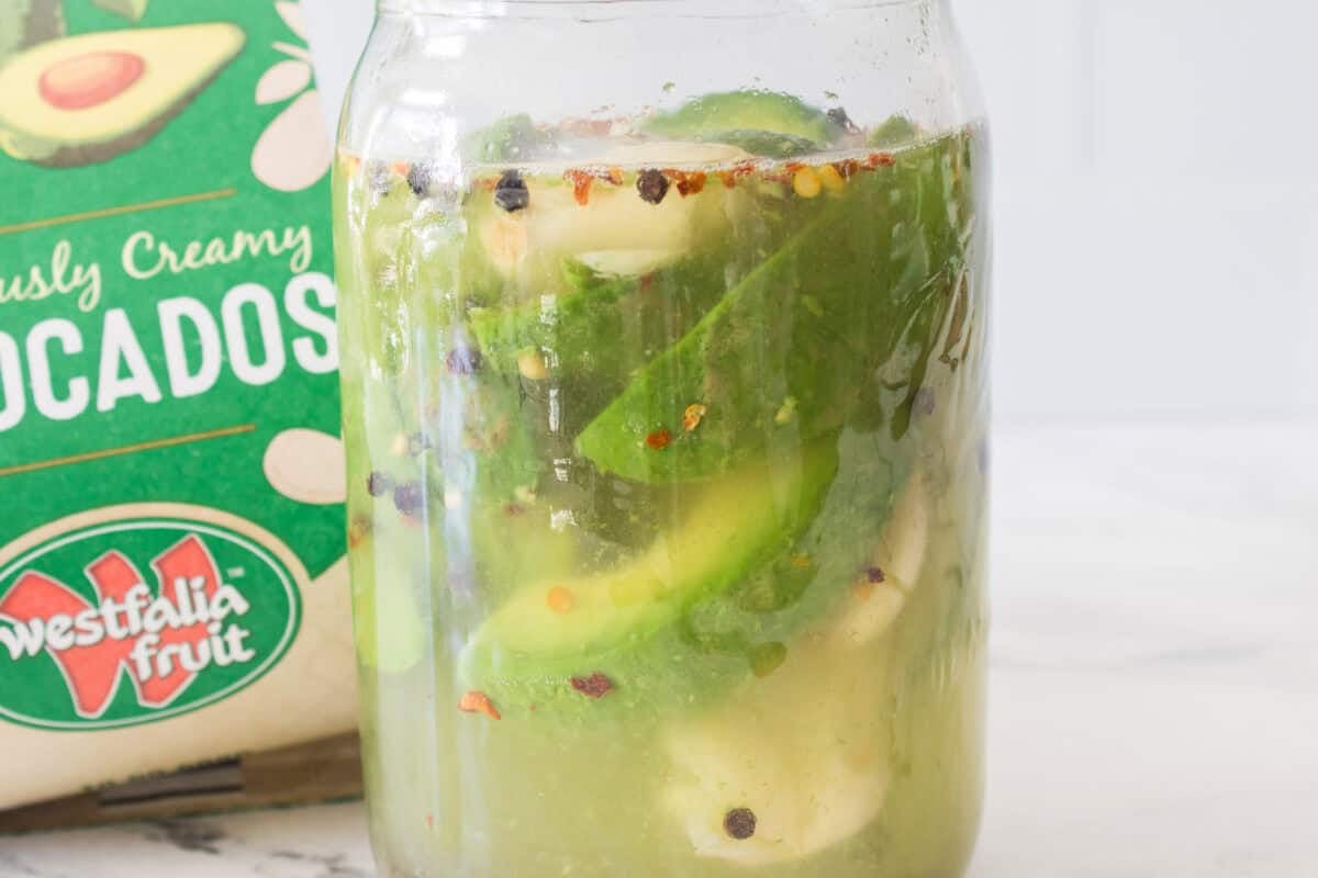 bag of westfalia fruit avocados with big mouth mason jar with avocados, peppercorns, red pepper flakes and sugar