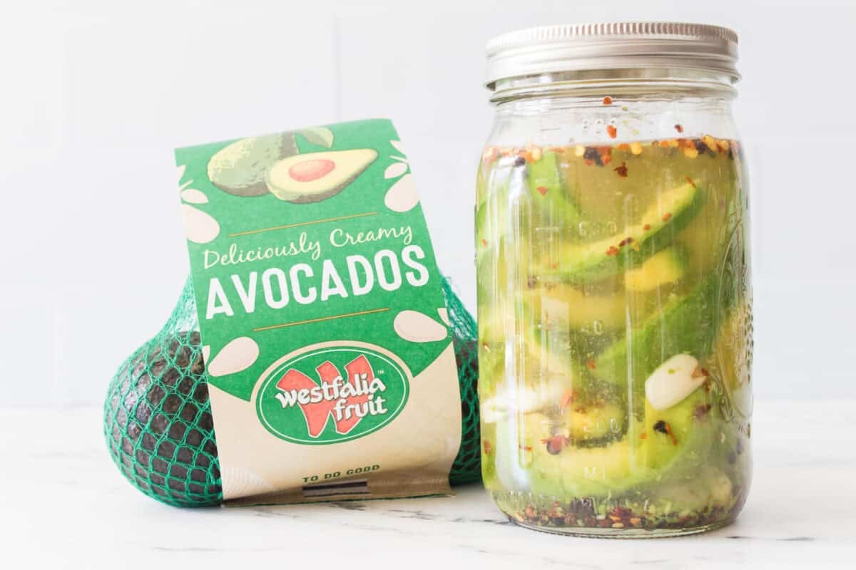 bag of westfalia fruit avocados and big mouth mason jar with pickled avocados