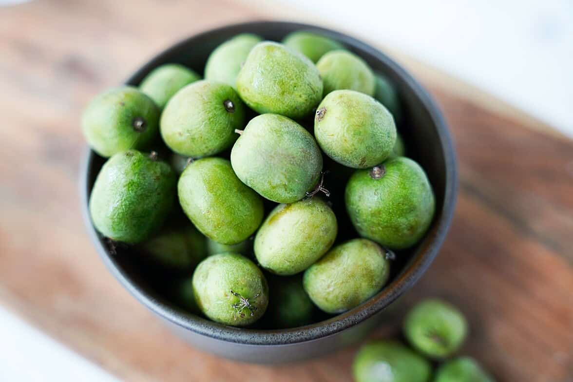 a bowl of whole kiwi berries