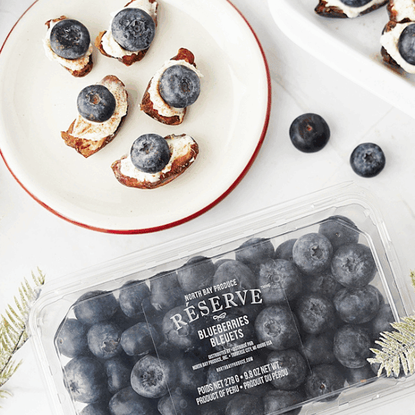 Blueberry mascarpone stuffed dates on a plate with North Bay Reserve blueberry package ab the bottom