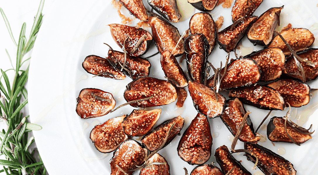 Close up of oven roasted figs on a white plate