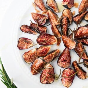 Vertical image of oven roasted figs on a plate