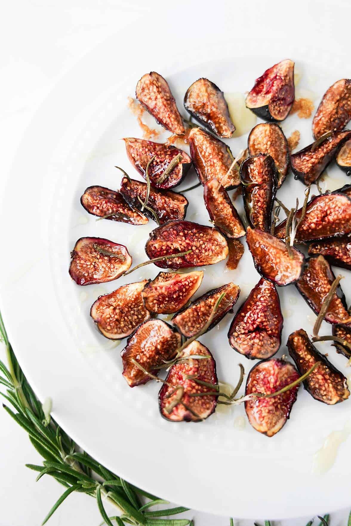 Vertical image of oven roasted figs on a plate