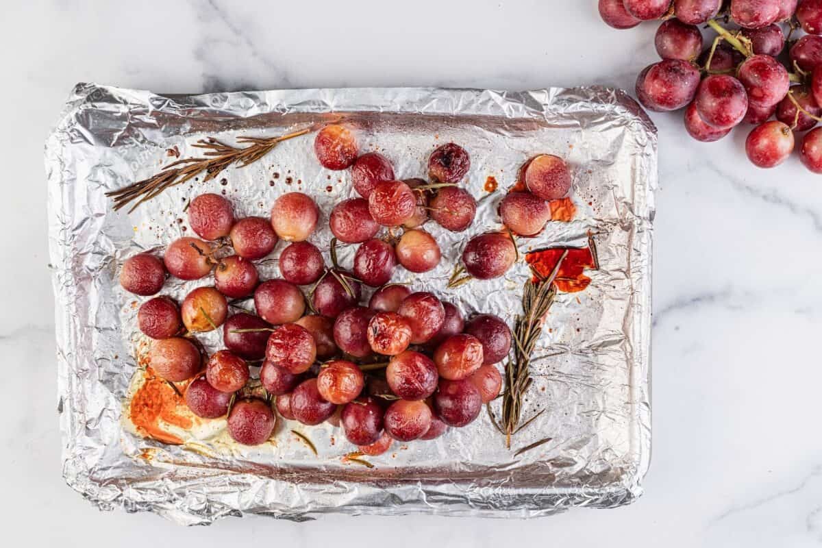 Roasted grapes on a sheet pan.