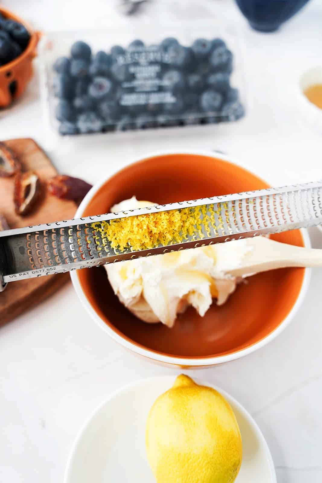 Zesting a lemon into bowl with mascarpone 