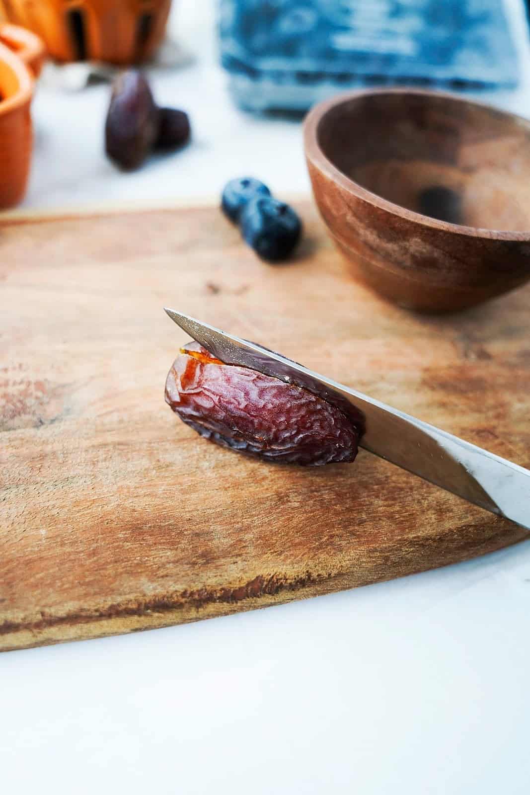 cutting a date with knife on cutting board
