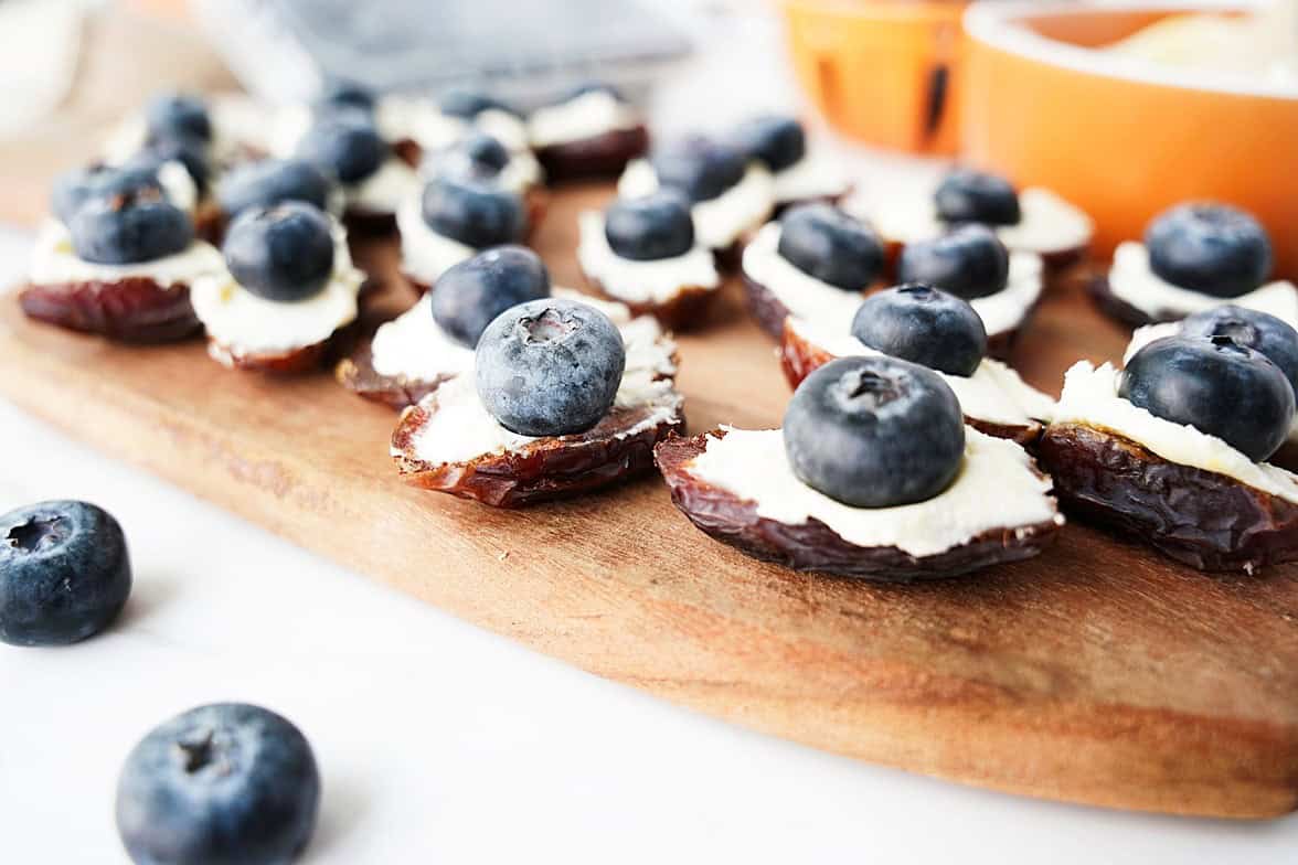 topping the stuffed dates with North Bay Reserve blueberries