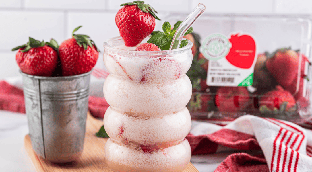 Strawberry Dirty Soda in glass surrounded by Naturipe strawberries