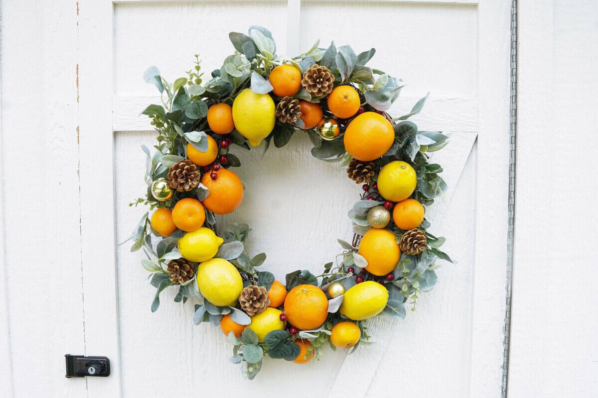 Citrus Christmas reath on white barn door
