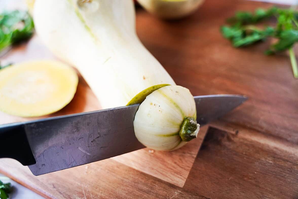 cutting the ends of a butternut squash