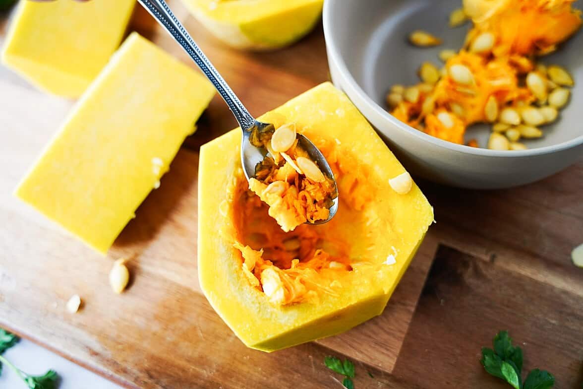 Removing the seeds from a butternut squash